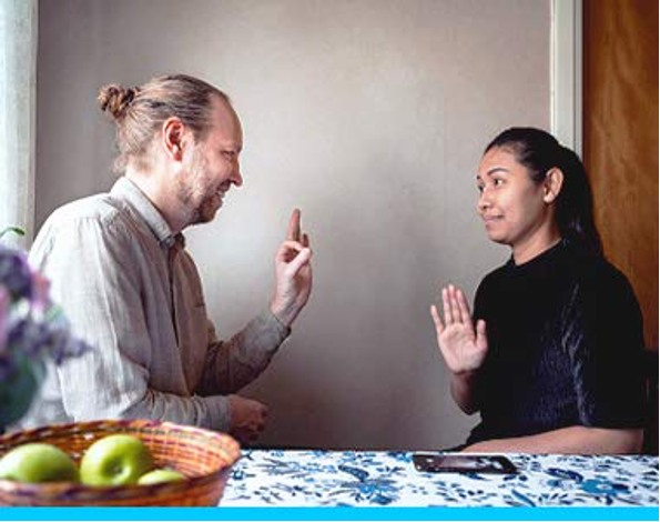 A man and a woman communicating using sign language