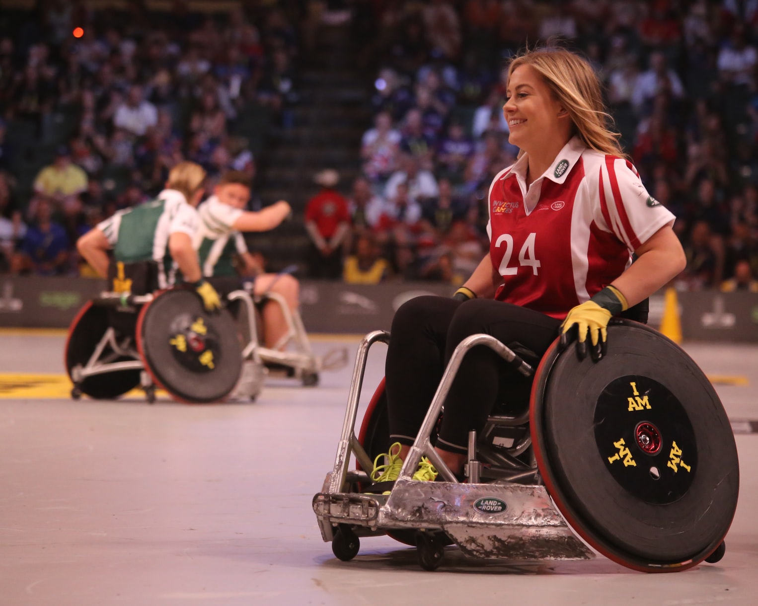 Image shows a woman in a wheelchair wearing a sporting top