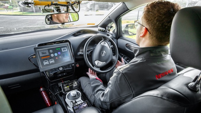 Colour photo of a Nissan engineer in the Nissan Leaf car