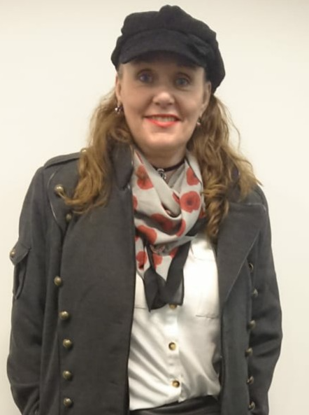 A picture of Pamela Bateman Lee. She wears a cap and a scarf with poppies on it