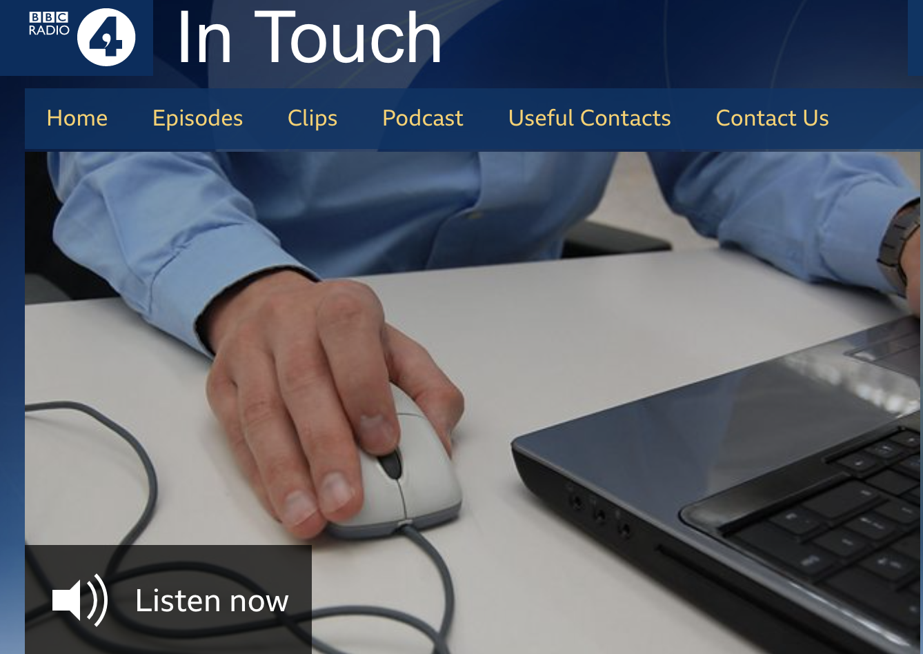 Screenshot of webpage showing the In Touch website area, with man operating mouse and computer on desk