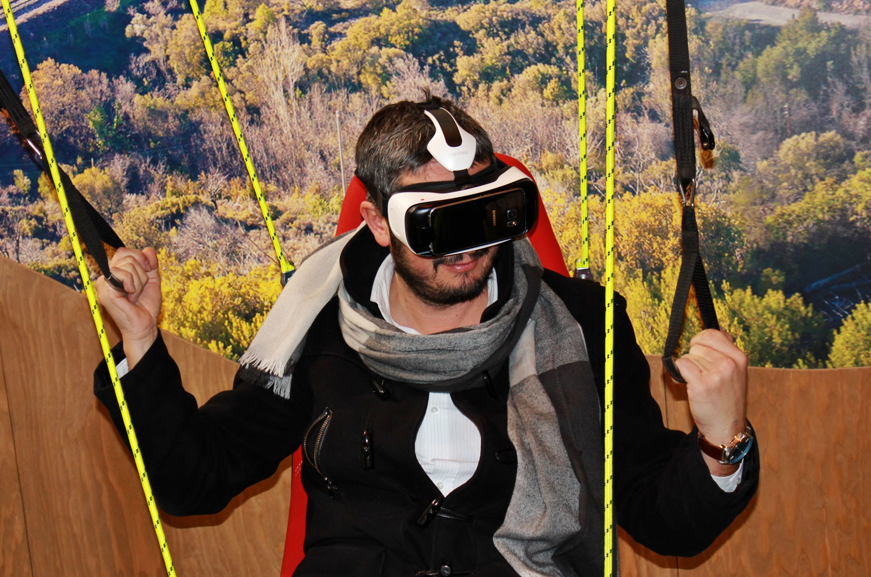 man wearing VR glasses with a countryside background
