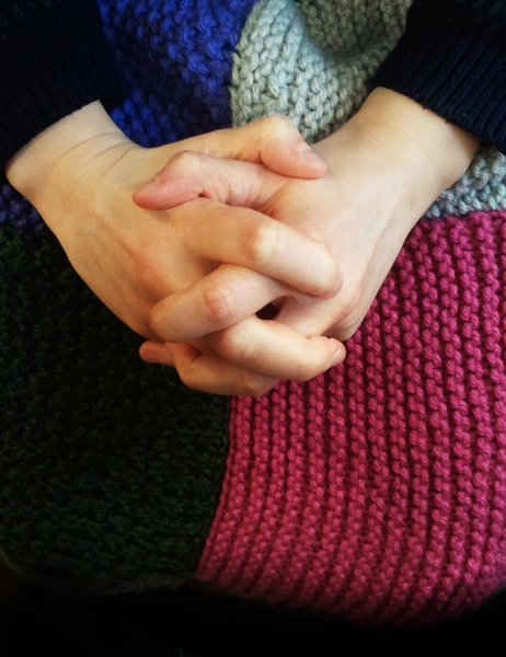 an older lady's hands folded into her lap