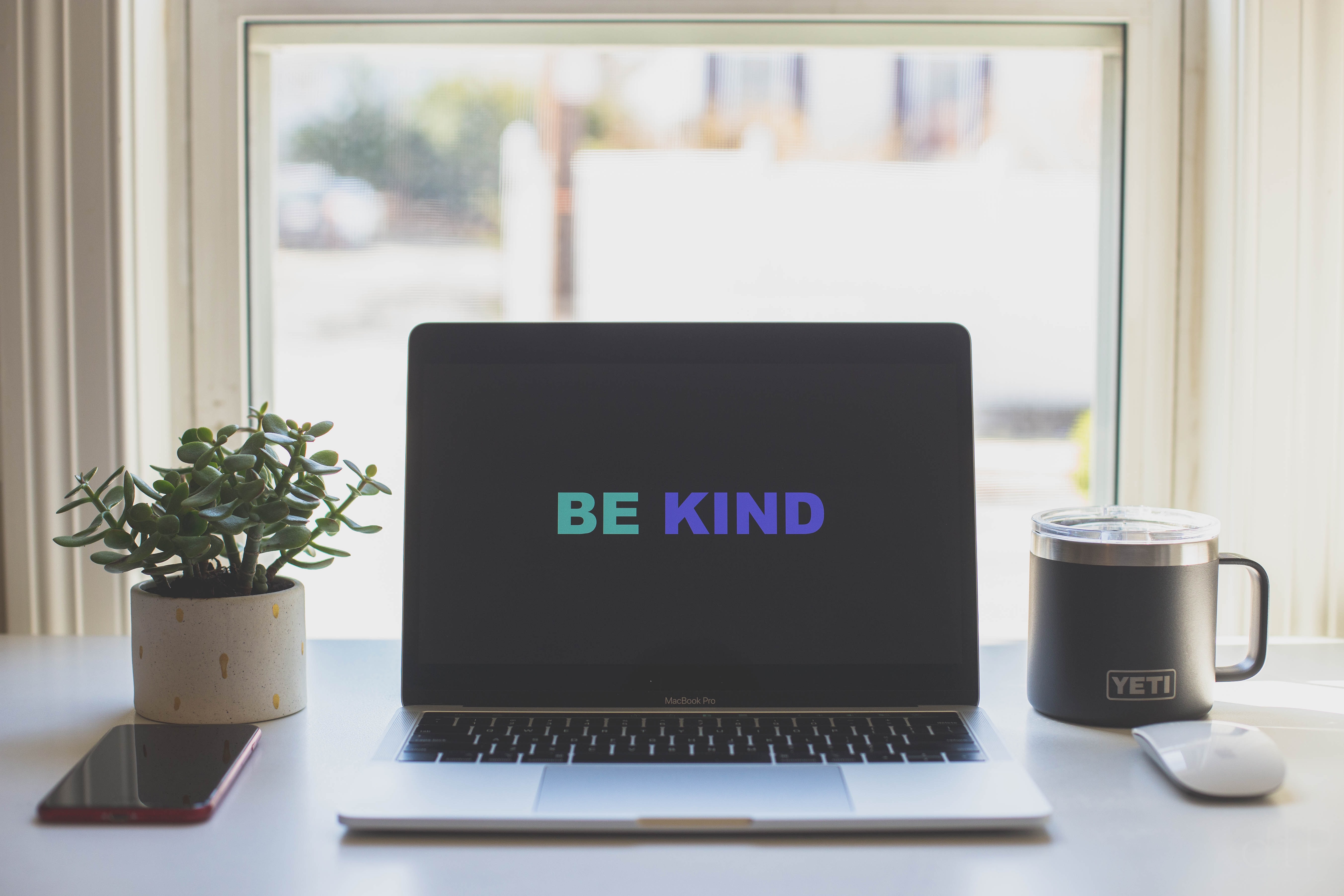 Laptop screen saying Be Kind