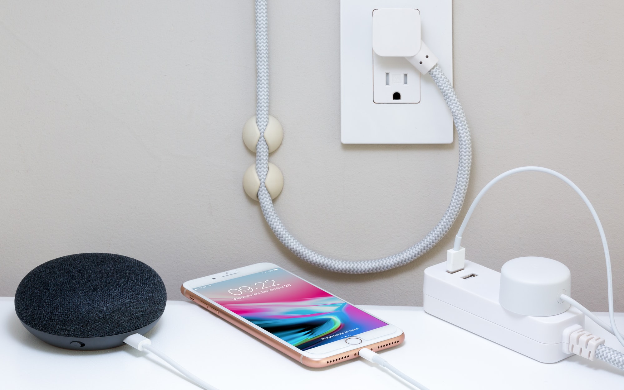 Picture of a smartphone and a smart speaker wired into a socket