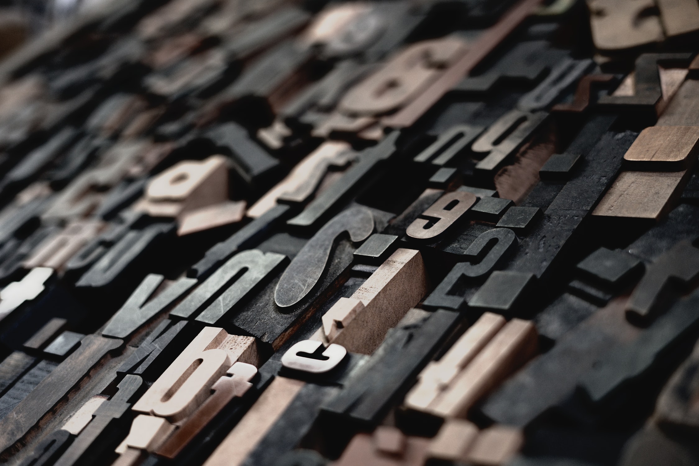 Image shows a jumble of printing blocks with letters on them