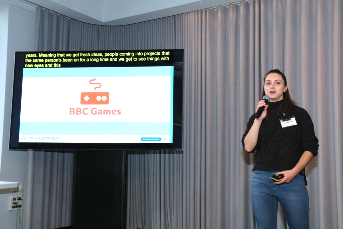 Lauren Moore on stage at TechShare Pro speaking about BBC Games