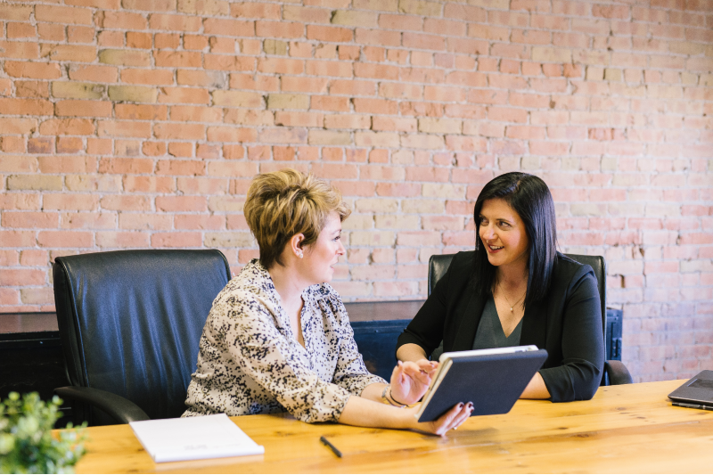 Two professional women sitting in meeting