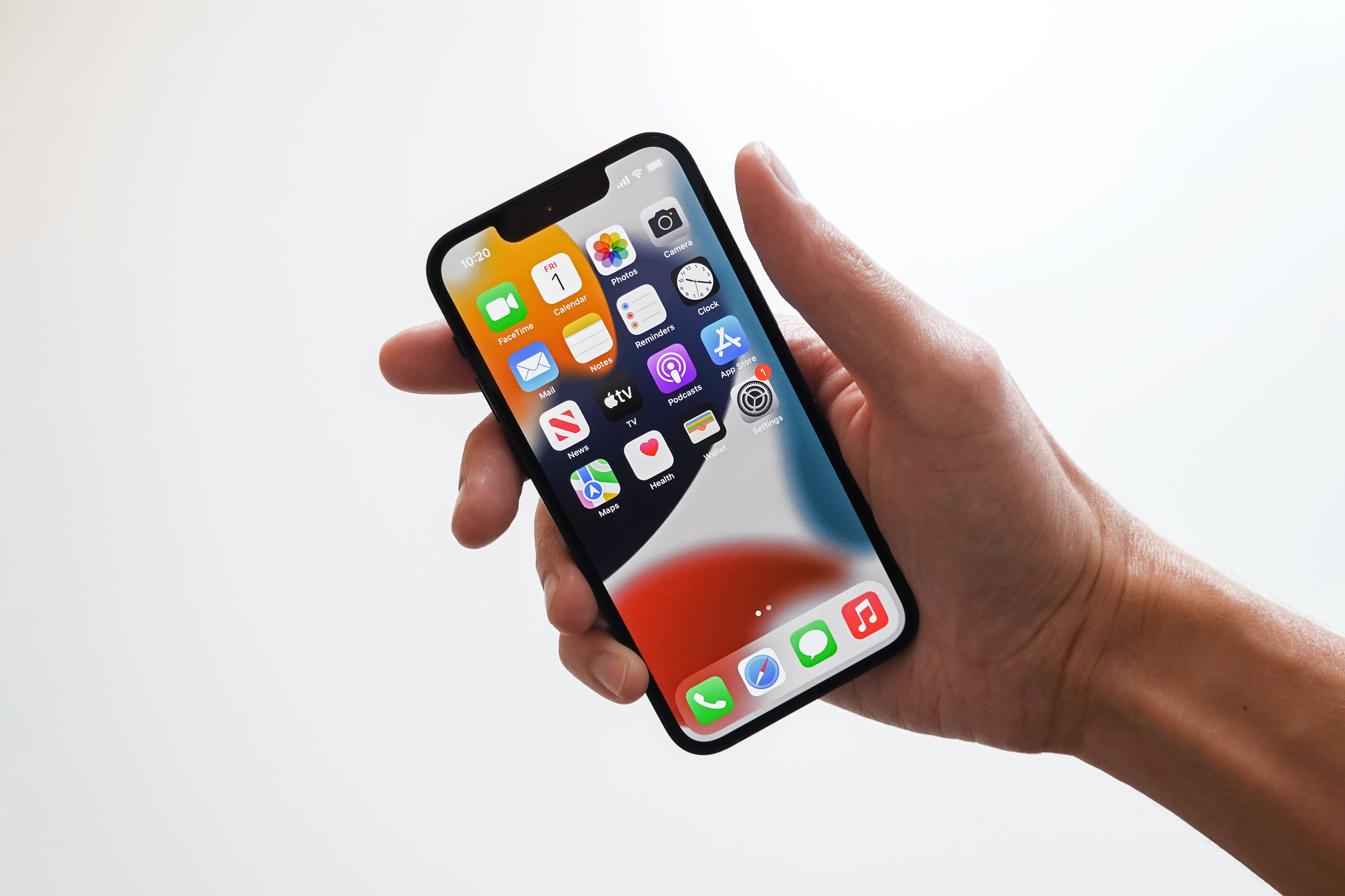 Person holding Iphone showing screen icons