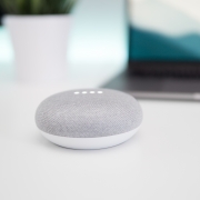 A Google Home Mini speaker on a white surface