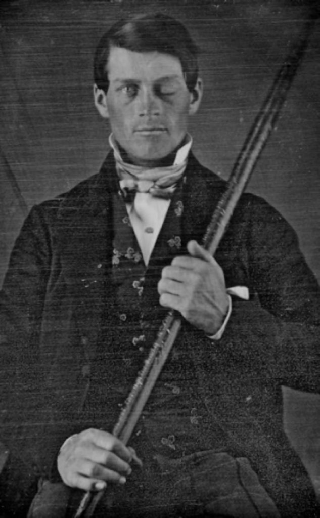 A black and white photo of Phineas Gage holding a tamping iron