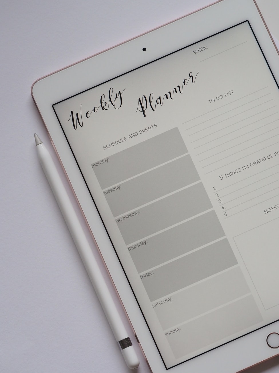 The words weekly planner are visible on a digital tablet