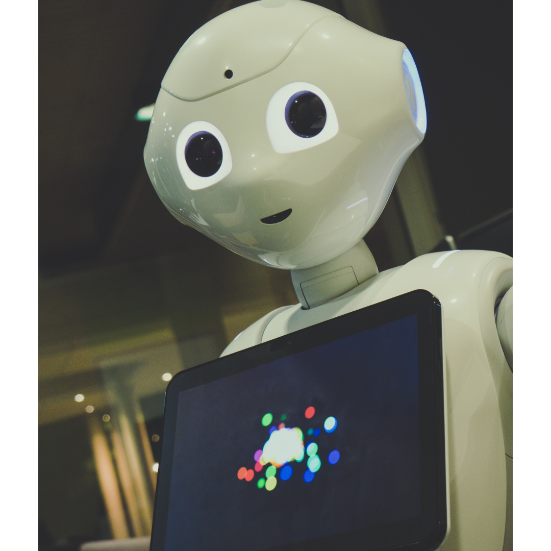 A robot smiling holding a smart tablet