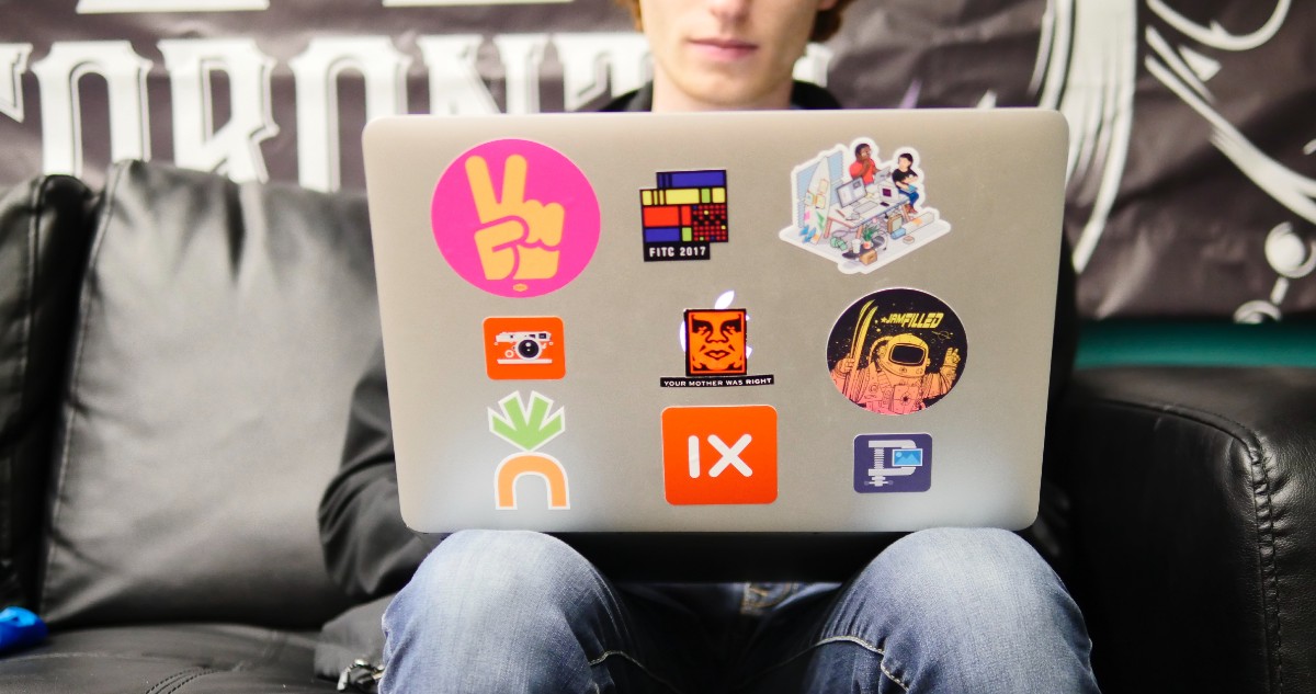Image of student using laptop while sitting on sofa