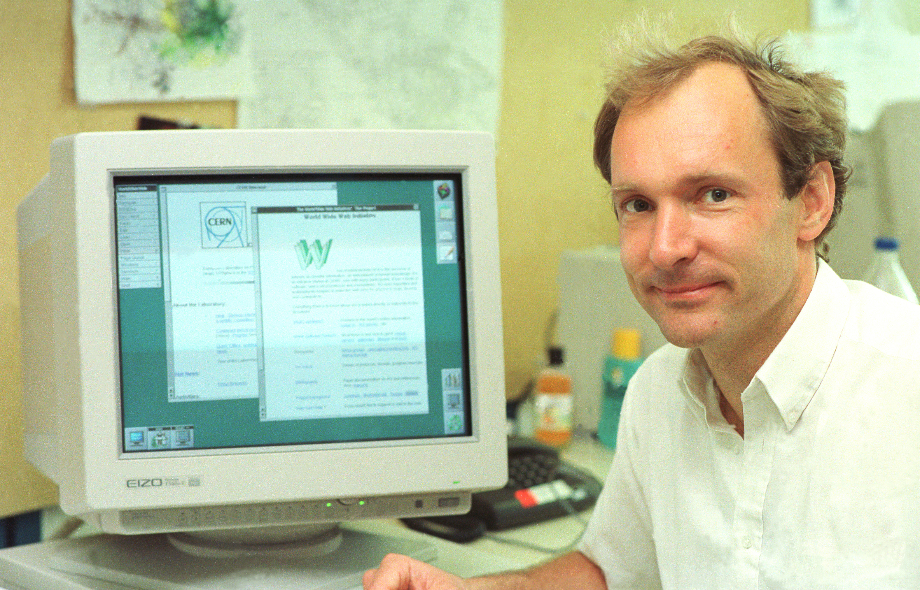 A young Tim Berners-Lee sits in front of an old style computer monitor. Source: CERN
