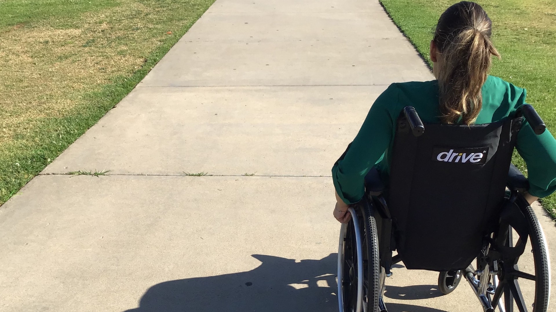 Student in a wheelchair on pathway