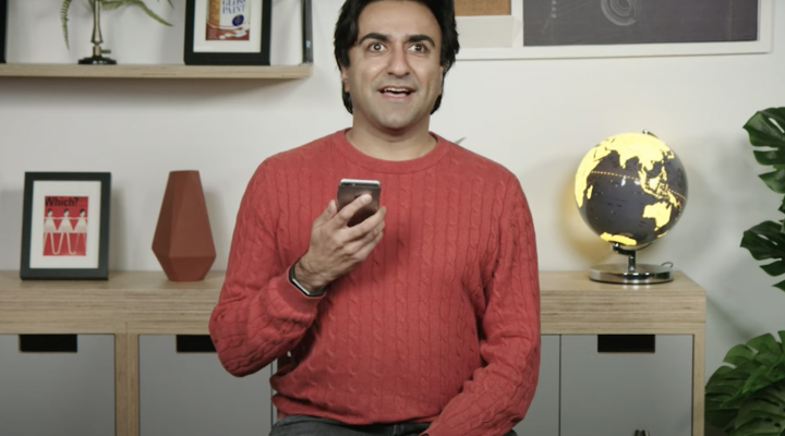 Adi Latif sitting in a room holding a phone